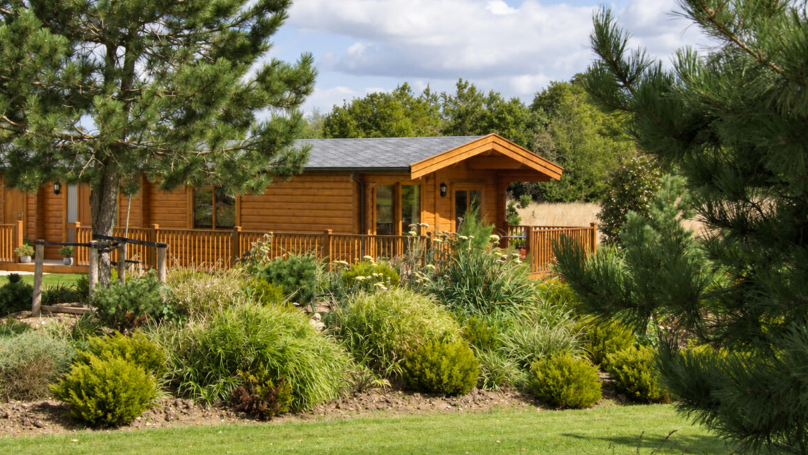 Naturally at home among the trees A Norwegian Log cabin with a timber terrace overlooking a leafy garden